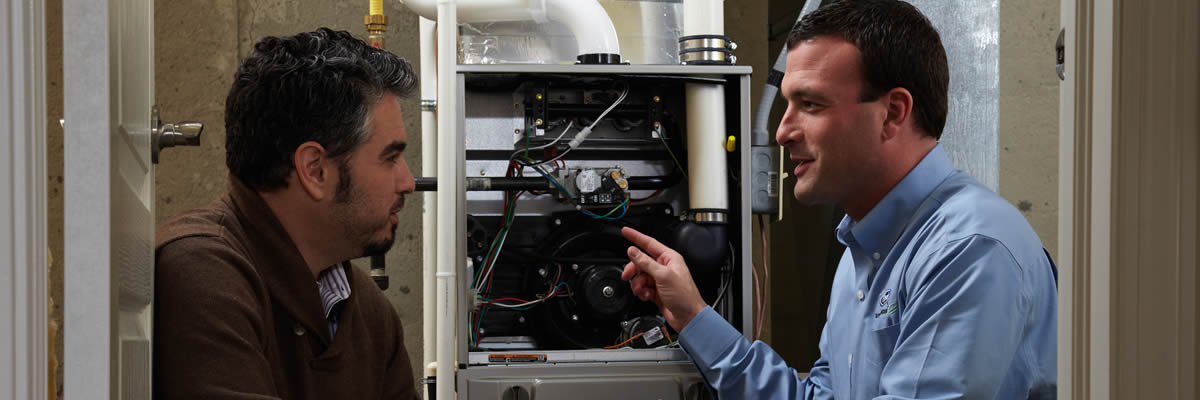 Hvac Tech Explaining The Trane Furnace To Homeowner