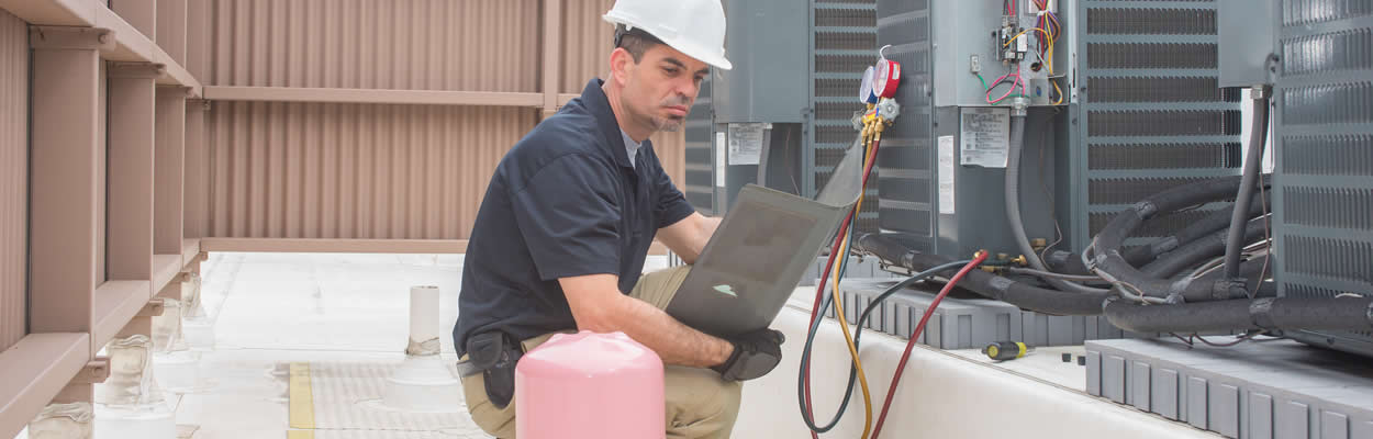 Hvac Tech Repairing Commercial Unit